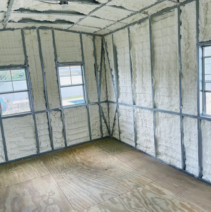 Closed-cell spray foam insulation applied to wall cavities in a residential project in Hialeah